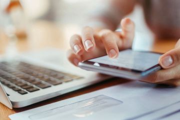 Laptop computer and worker using calculator