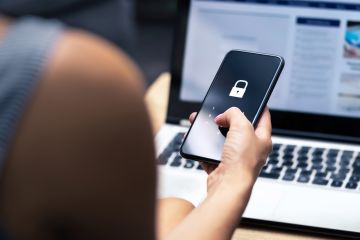 Person holding phone with locked icon symbolising security. 